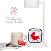 The Time Timer MOD 60 Minute Visual Timer is shown sitting under a desk lamp next to other office and teacher supplies. There is a icon that states "Intuitive Assistive Tech" and it reads "Time Timer visual timers are research proven to increase self-regulation in all ages and abilities."