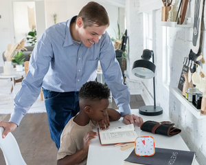 A child using a timer in person to manage their time reading 