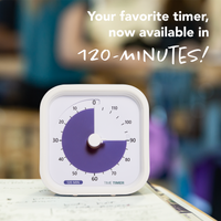 A Time Timer MOD - 120 Minute visual timer is shown sitting on a desk with paperwork underneath. The purple disk is set at the 90 minute mark. There is text overlaying the photo that states "Your favorite visual timer, no available in 120 minutes!"
