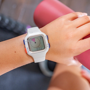 Digital watch on a wrist with a blurred background