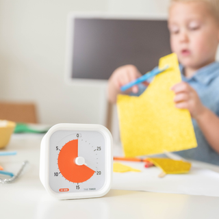Children's timer on a table with a child in the background