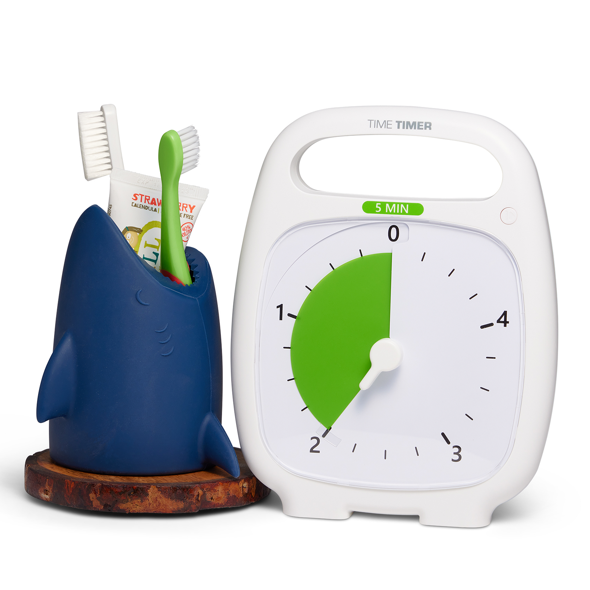 The Time Timer PLUS 5 minute visual timer is shown alongside a shark shaped toothbrush holder. The holder contains 2 toothbrushes and a small tube of toothpaste. The timer's green disk is set at 2 minutes - perfect for brushing teeth!