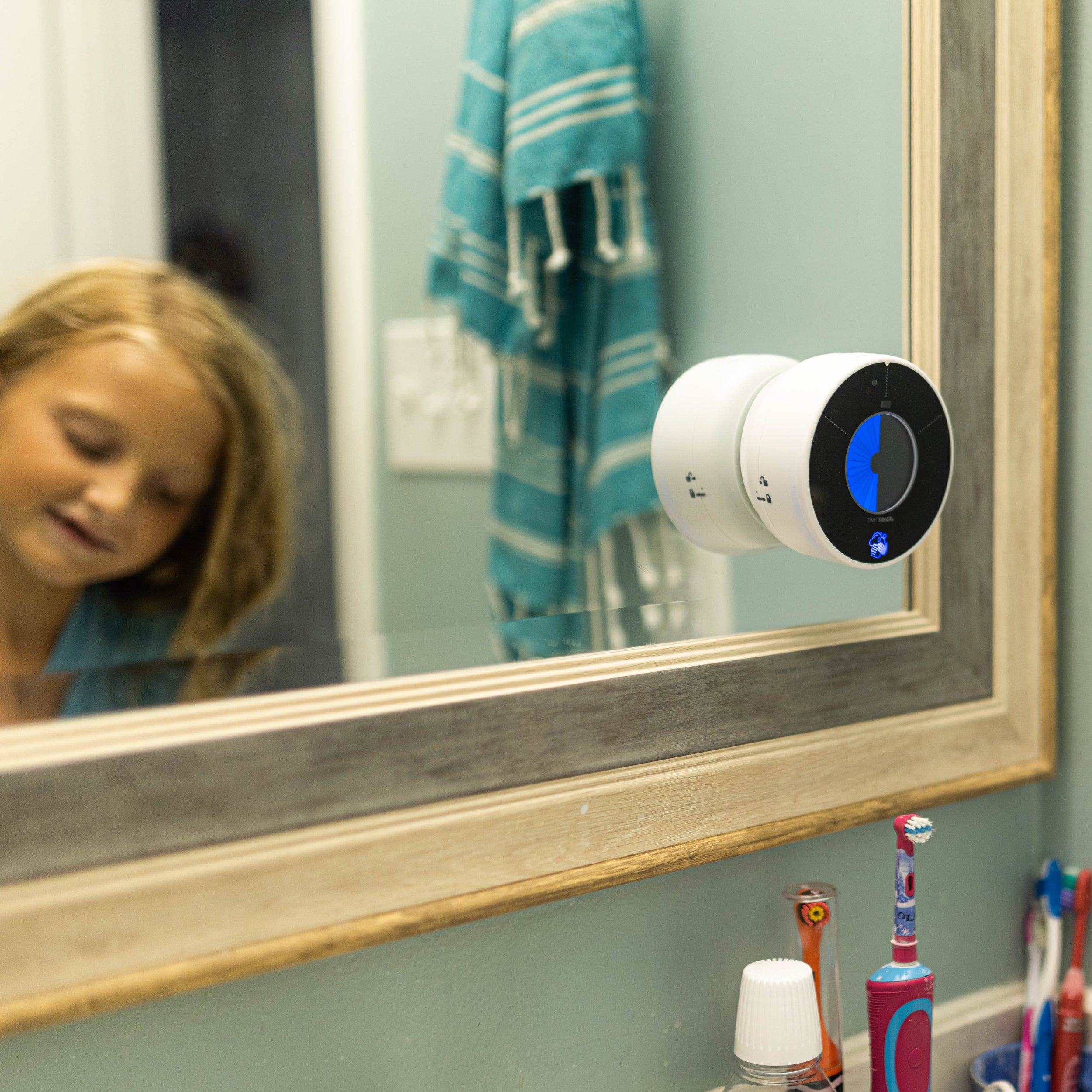 A child using the Time Timer WASH at home to wash her hands properly 