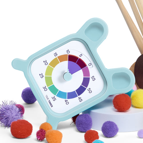 Color wheel timer with colorful pom-poms on a white background