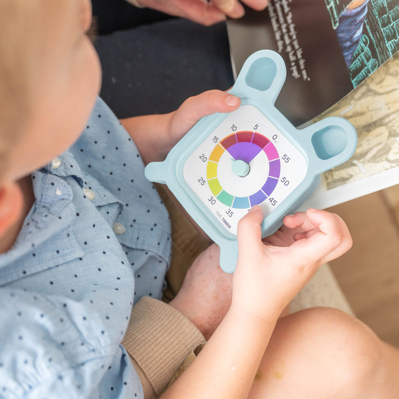 Child holding a colorful temperature gauge toy