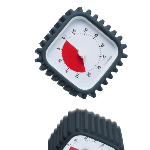 Time Timer 60-minute visual timer is outfitted with a rugged charcoal silicone case. It is falling through the air. 