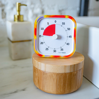 Time Timer in a bathroom, setting a top a wood canister. 
