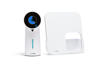 Two white electronic devices with digital displays on a white background 