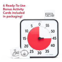 Time Timer® Original 8” - 6 ready to use bonus activity cards included in packaging. Visual timer with red disk is set at 45 minutes. Three cardboard cut-out activity cards are shown near by. One depicts a school bus. Another shows a plate with a sandwich, apple and drink to imply a mealtime. And a third shows a face with open mouth and teeth with toothbrush to visually represent brushing teeth. 