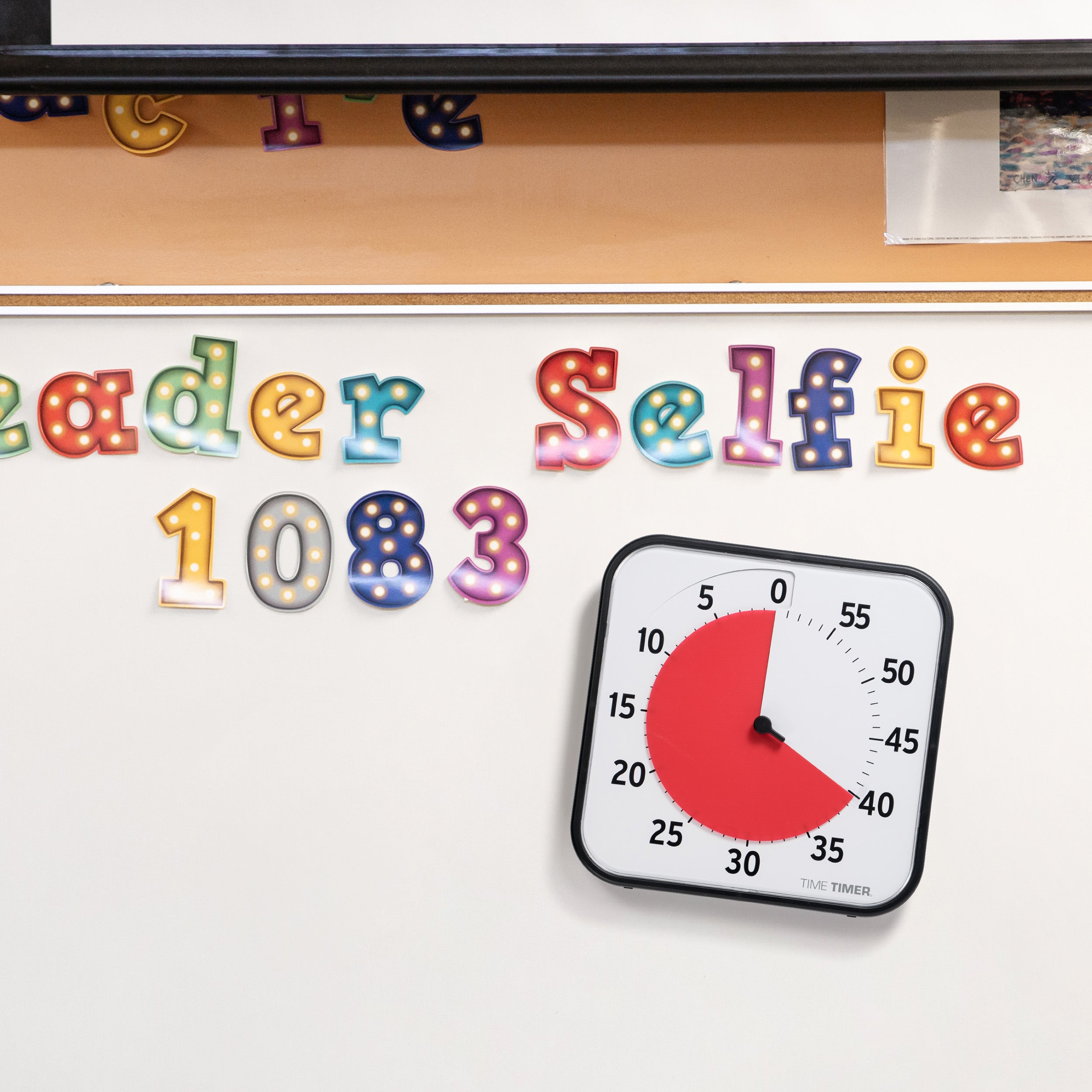 The Time Timer Original 12" has a magnetic back and is shown on a classroom whiteboard. 