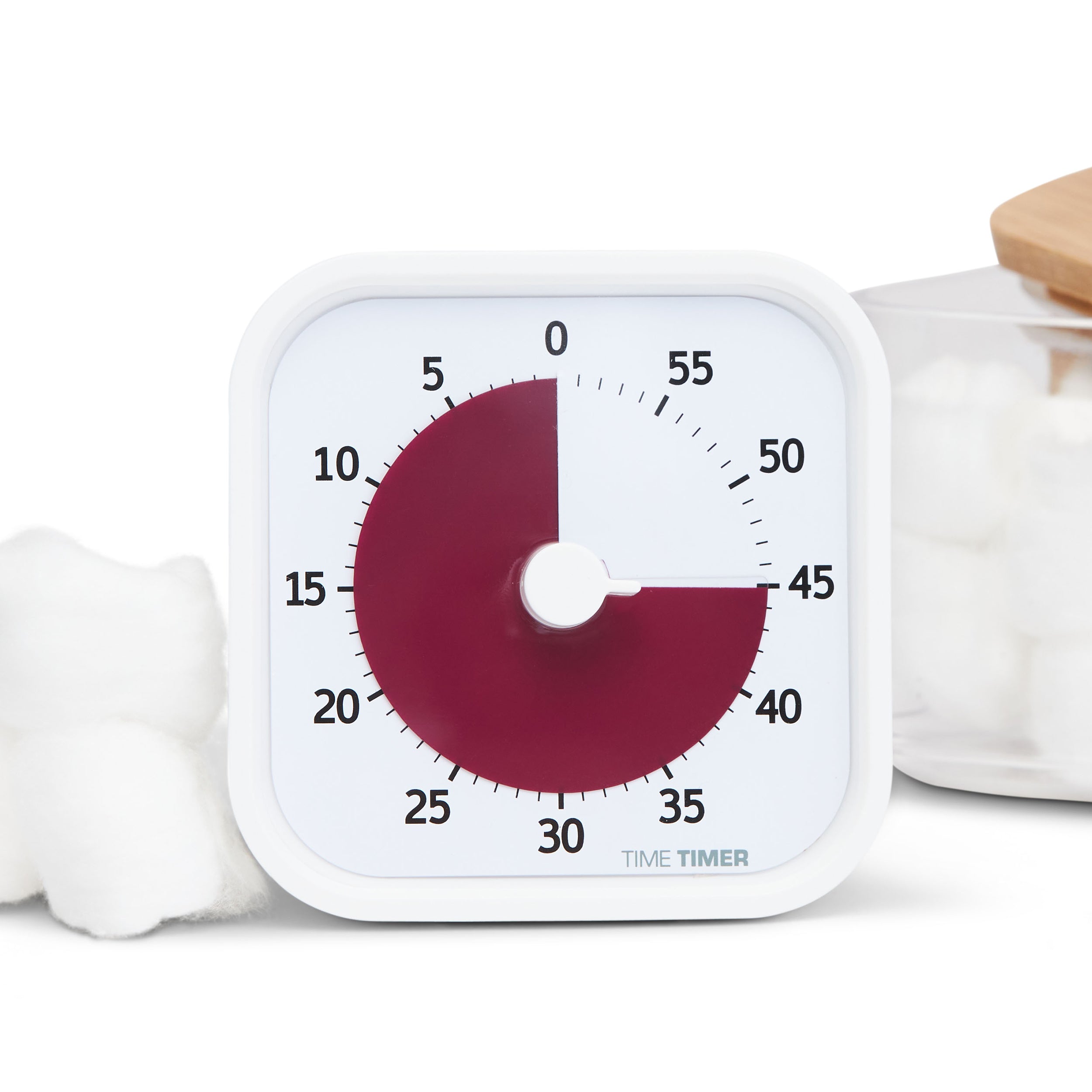 Time Timer MOD - Home Edition Visual Timer for kids and adults. This visual timer is a crisp white exterior with a burgundy disk. A very sophisticated look, pictured with fluffy white cotton balls surrounding it.  